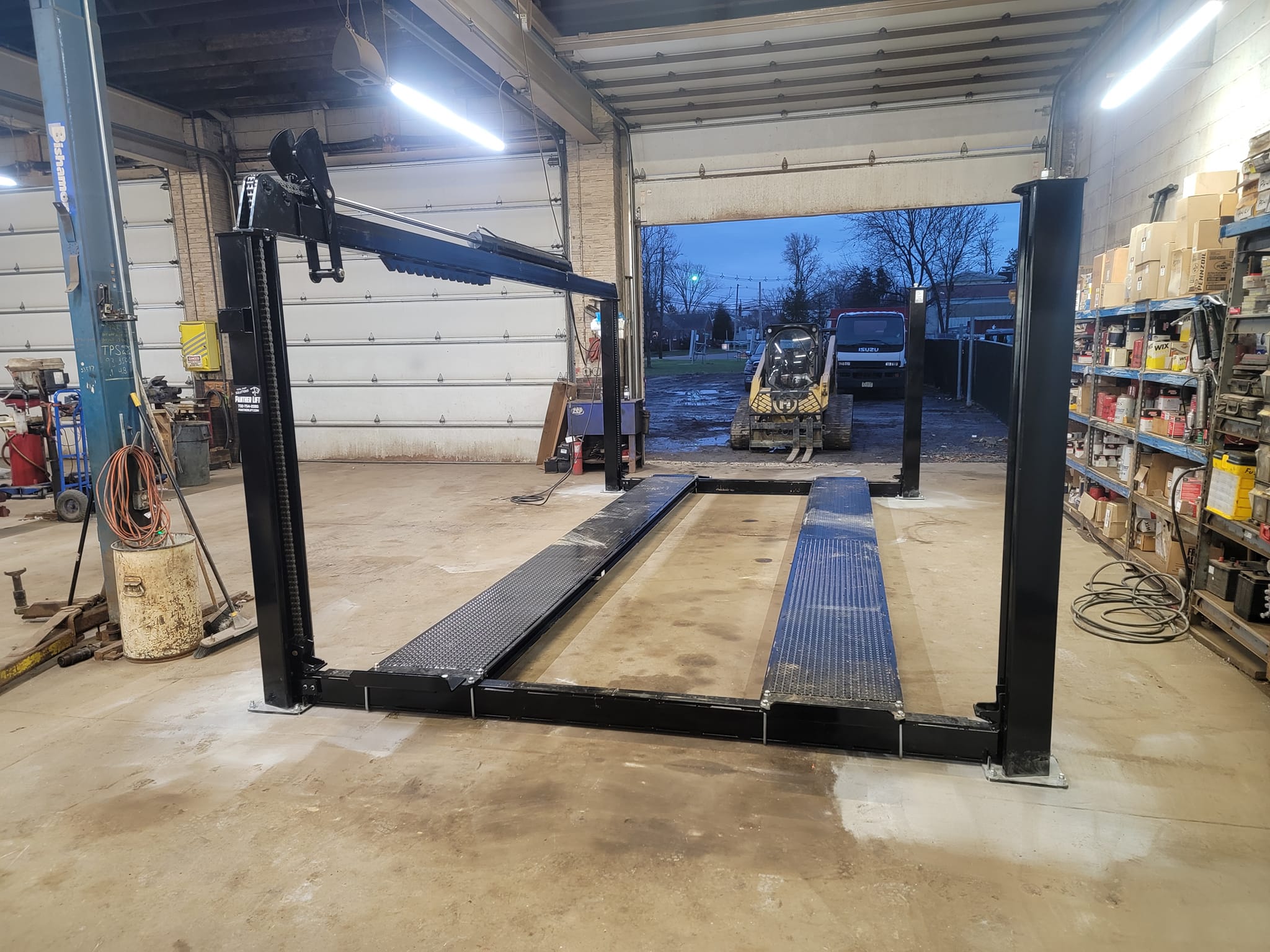 4-post lift installation in service bay