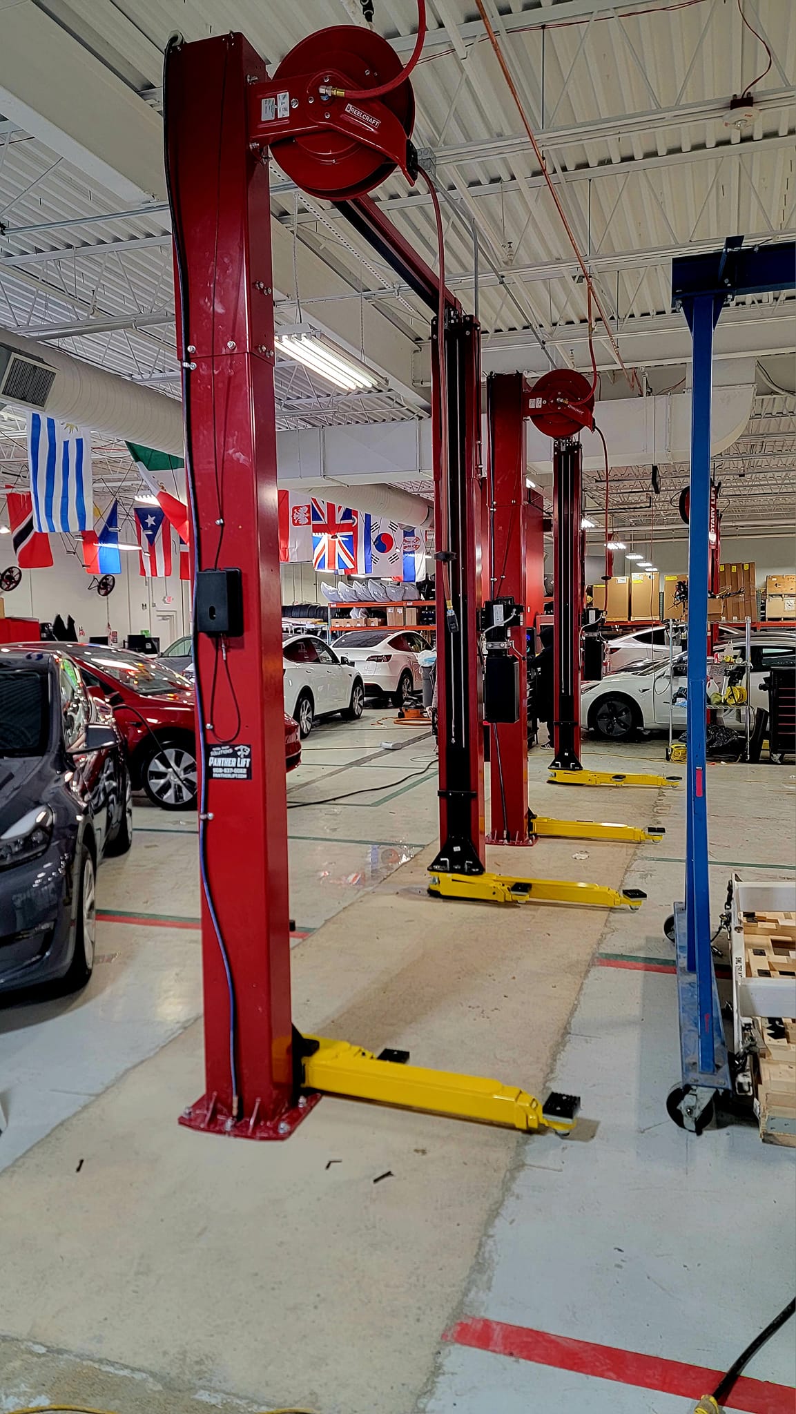 2-post lift installation in commercial shop bay